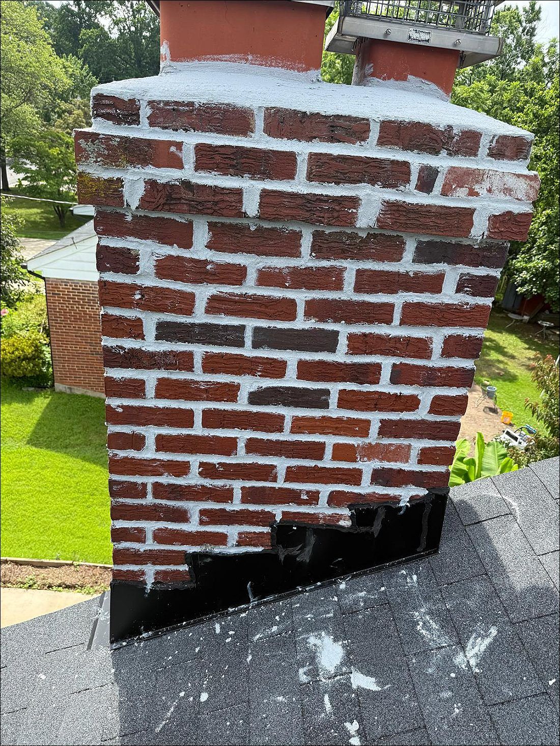 Brick chimney with a stainless chimney cap installed