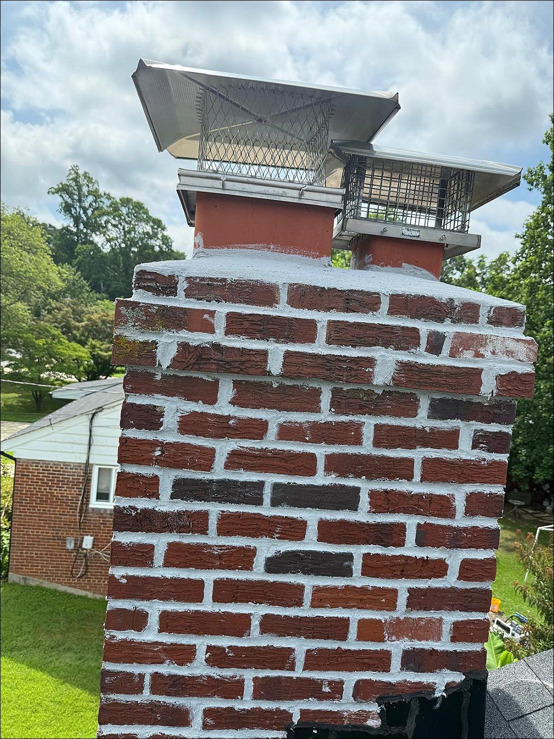 Brick chimney with two stainless caps, well maintained