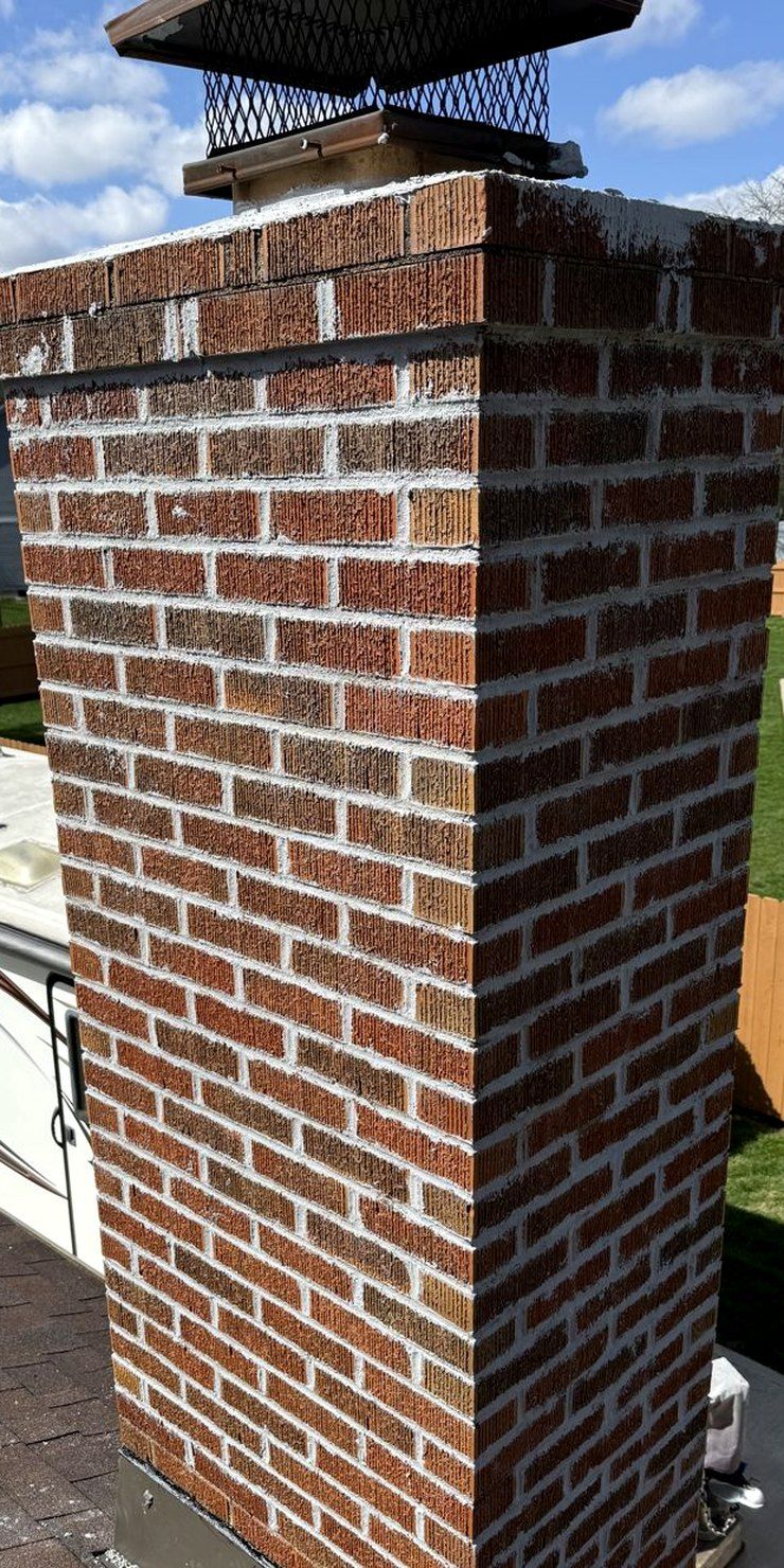 Brick chimney with repointed joints, a sealed crown and a new stainless cap, finished by Northmark