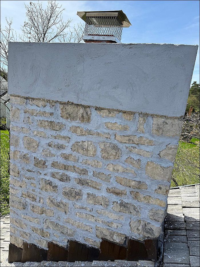 Stone chimney with new crown and flashing